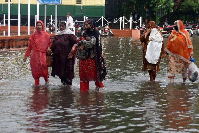(260722) -- LAHORE, July 22, 2026 (Xinhua) -- People wade through a flooded street after heavy monsoon rains in Lahore, Pakistan, July 22, 2026.
  At least eight people were killed and 16 others injured in rain-related incidents across Pakistan over the past 24 hours as monsoon showers continued to batter parts of the country, the National Disaster Management Authority said on Tuesday. (Photo by Sajjad/Xinhua)