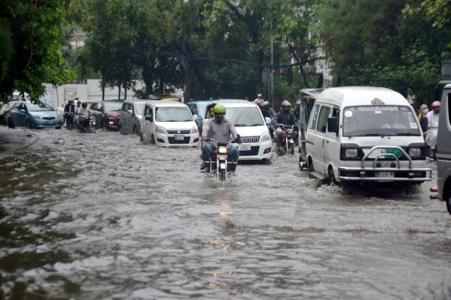 (260722) -- LAHORE, July 22, 2026 (Xinhua) -- Vehicles move on a flooded street after heavy monsoon rains in Lahore, Pakistan, July 22, 2026.
  At least eight people were killed and 16 others injured in rain-related incidents across Pakistan over the past 24 hours as monsoon showers continued to batter parts of the country, the National Disaster Management Authority said on Tuesday. (Photo by Sajjad/Xinhua)