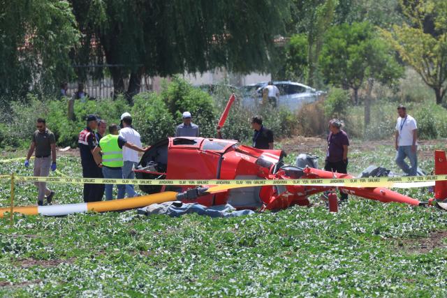 (260722) -- ANKARA, July 22, 2026 (Xinhua) -- Emergency service personnel work at the site where a training helicopter crashed in the Temelli neighborhood, in Ankara, Türkiye, on July 22, 2026. One pilot was killed and another injured when a training helicopter crashed in Türkiye's capital Ankara on Wednesday, authorities said. (Mustafa Kaya/Handout via Xinhua)