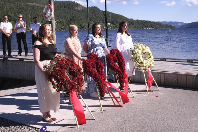 (260722) -- UTOYA, July 22, 2026 (Xinhua) -- Representatives stand beside wreaths during a memorial event marking the 15th anniversary of the July 22, 2011 terror attacks on Utoya Island, Norway, July 22, 2026. Norwegian Prime Minister Jonas Gahr Store on Wednesday warned of the growing threat of far-right radicalization among young people, saying social media, artificial intelligence and social isolation were fueling extremism, as the country marked the 15th anniversary of the July 22, 2011 terror attacks. (Xinhua/Zhang Yuliang)