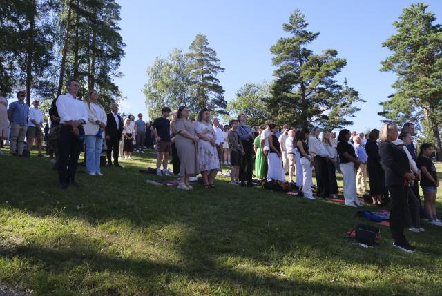 (260722) -- UTOYA, July 22, 2026 (Xinhua) -- People observe a moment of silence during a memorial event marking the 15th anniversary of the July 22, 2011 terror attacks on Utoya Island, Norway, July 22, 2026. Norwegian Prime Minister Jonas Gahr Store on Wednesday warned of the growing threat of far-right radicalization among young people, saying social media, artificial intelligence and social isolation were fueling extremism, as the country marked the 15th anniversary of the July 22, 2011 terror attacks. (Xinhua/Zhang Yuliang)