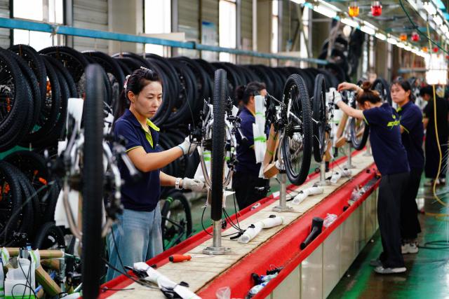 (260723) -- BEIJING, July 23, 2026 (Xinhua) -- Workers assemble bicycles in a workshop of a bicycle company in Pingxiang County, Xingtai City, north China's Hebei Province, July 22, 2026. Xingtai City is a nationally renowned bicycle manufacturing base, with its products sold worldwide.
   In recent years, Xingtai has pushed forward the upgrading of the bicycle industry, continuously improved cycling infrastructure, and hosted a wide range of professional cycling races and mass public riding events. By integrating manufacturing and cycling events, the city has fueled accelerated growth of the local bicycle sector. (Photo by Feng Yichao/Xinhua)