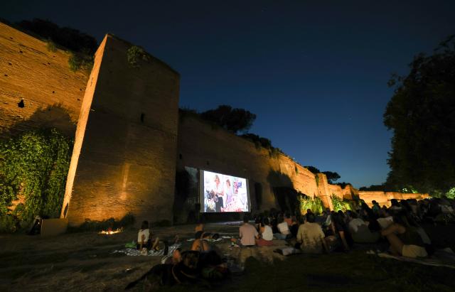 (260723) -- ROME, July 23, 2026 (Xinhua) -- People watch a film during the summer edition of the Cinema Alle Mura festival in front of the ancient Aurelian Walls Park in Rome, Italy, July 22, 2026. (Xinhua/Wang Kaiyan)