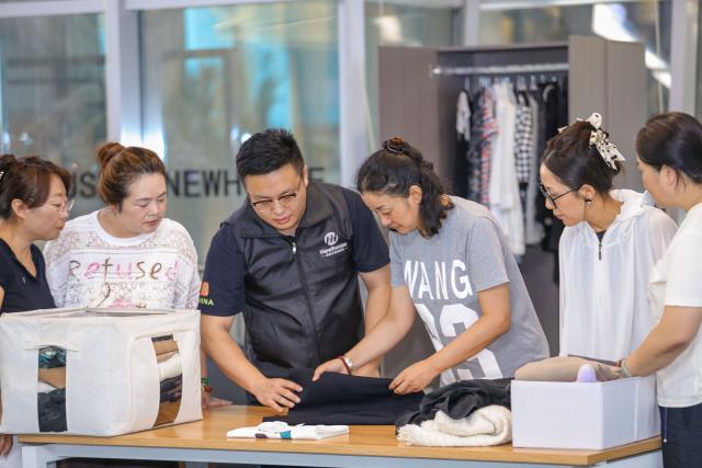 (260723) -- JINAN, July 23, 2026 (Xinhua) -- An instructor teaches trainees to organize clothing at a training center of domestic services in Qingdao City, east China's Shandong Province, July 21, 2026. A number of domestic services brands have emerged in Shandong in recent years, offering widely ranging services such as eldercare, maternity care, and in-home caregiving. (Photo by Zhang Ying/Xinhua)