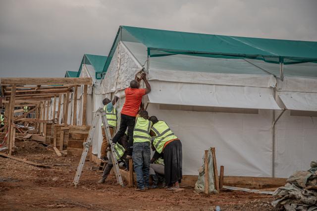 (260723) -- KINSHASA, July 23, 2026 (Xinhua) -- Workers build an Ebola treatment center in Beni territory of North Kivu Province, the Democratic Republic of the Congo (DRC), on July 22, 2026. Over two months, the fastest-in-the-world Ebola outbreak in the Democratic Republic of the Congo (DRC) has left more than 1,000 dead. (Xinhua)