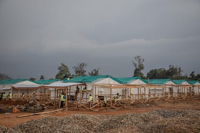 (260723) -- KINSHASA, July 23, 2026 (Xinhua) -- Workers build an Ebola treatment center in Beni territory of North Kivu Province, the Democratic Republic of the Congo (DRC), on July 22, 2026. Over two months, the fastest-in-the-world Ebola outbreak in the Democratic Republic of the Congo (DRC) has left more than 1,000 dead. (Xinhua)