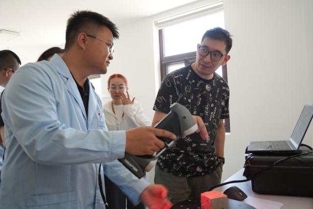 (260723) -- DUNHUANG, July 23, 2026 (Xinhua) -- Trainees of the 2026 international training program on Silk Road heritage conservation attend a class in Dunhuang, northwest China's Gansu Province, July 21, 2026. TO GO WITH "China Focus: Retracing Silk Road, young researchers gather to protect shared heritage" (Xinhua/Ma Sha)