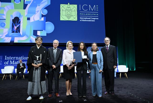 (260723) -- PHILADEPHIA, July 23, 2026 (Xinhua) -- Chinese mathematician Wang Hong (3rd R) is awarded the Fields Medal at the opening ceremony of the 2026 International Congress of Mathematicians in Philadelphia, the United States, July 23, 2026. Chinese mathematicians Deng Yu and Wang Hong were awarded the Fields Medals at the opening ceremony of the 2026 International Congress of Mathematicians held here on Thursday, marking the first time Chinese mathematicians have won the prestigious honor. The other recipients of the 2026 Fields Medals are American John Pardon and Canada's Jacob Tsimerman. (Xinhua/Li Rui)