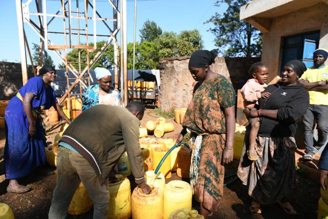 (260723) -- MARSABIT, July 23, 2026 (Xinhua) -- Local residents fill water containers at a public water intake point built by Power Construction Corporation of China in Marsabit, Kenya, July 14, 2026. TO GO WITH "Feature: Chinese-built water project transforms life in Kenya's arid town" (Xinhua/Liu Qiong)