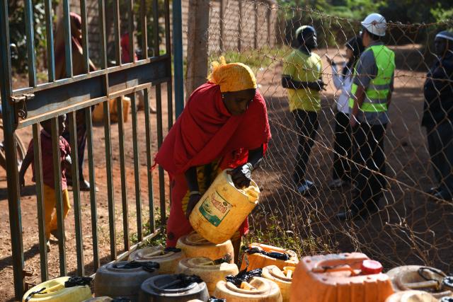 (260723) -- MARSABIT, July 23, 2026 (Xinhua) -- A local resident fills water containers at a public water intake point built by Power Construction Corporation of China in Marsabit, Kenya, July 14, 2026. TO GO WITH "Feature: Chinese-built water project transforms life in Kenya's arid town" (Xinhua/Liu Qiong)