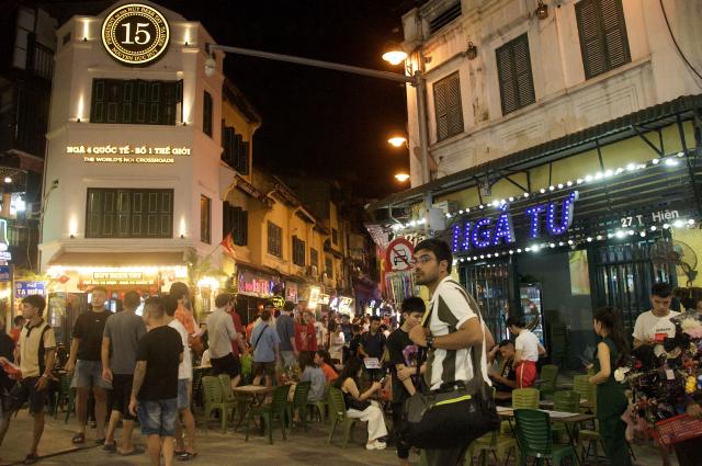(260724) -- HANOI, July 24, 2026 (Xinhua) -- Pedestrians are seen in the evening at the Old Quarter in Hanoi, Vietnam, July 23, 2026. Vietnam's capital Hanoi has unveiled a plan to develop its nighttime economy, aiming for the sector to contribute about 5 percent of the city's gross regional domestic product (GRDP) by 2030, the Vietnam News Agency reported on Thursday.
   TO GO WITH "Vietnamese capital targets nighttime economy to contribute 5 pct of GRDP by 2030" (Photo by Tran Kien/Xinhua)