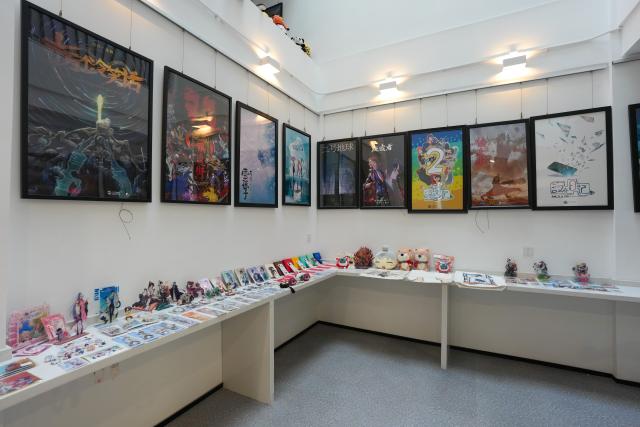 (260724) -- CHENGDU, July 24, 2026 (Xinhua) -- This photo taken on July 22, 2026 shows cultural and creative products at a studio in Tianfu Long Island Digital Cultural and Creative Park in Chengdu, southwest China's Sichuan Province. The animated film "All Wishes Come True" released nationwide recently has won praise for its fresh take on Chinese mythology and stunning visual effects. Following the resounding success of animation film series of "Ne Zha," it is another blockbuster developed at Tianfu Long Island Digital Cultural and Creative Park under the Chengdu High-Tech Industrial Development Zone. 
   The park is home to more than 70 digital cultural and creative enterprises covering sectors such as animation, game development and esports. The Chengdu High-Tech Industrial Development Zone, for its part, now hosts more than 6,000 companies in the digital cultural and creative industry, reflecting the city's rapidly growing creative economy. (Xinhua/Xu Bingjie)