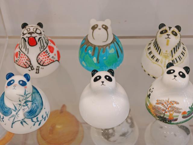 (260724) -- CHENGDU, July 24, 2026 (Xinhua) -- This photo taken on July 22, 2026 shows panda-shaped cups displayed at Tianfu Long Island Digital Cultural and Creative Park in Chengdu, southwest China's Sichuan Province. The animated film "All Wishes Come True" released nationwide recently has won praise for its fresh take on Chinese mythology and stunning visual effects. Following the resounding success of animation film series of "Ne Zha," it is another blockbuster developed at Tianfu Long Island Digital Cultural and Creative Park under the Chengdu High-Tech Industrial Development Zone. 
   The park is home to more than 70 digital cultural and creative enterprises covering sectors such as animation, game development and esports. The Chengdu High-Tech Industrial Development Zone, for its part, now hosts more than 6,000 companies in the digital cultural and creative industry, reflecting the city's rapidly growing creative economy. (Xinhua/Bao Feifei)