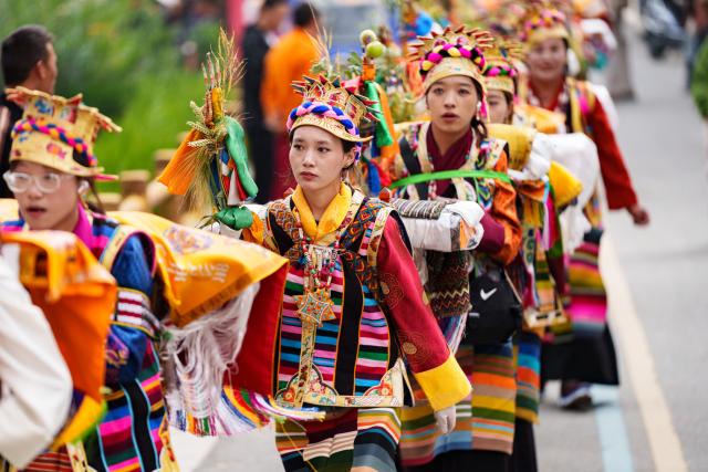 (260724) -- SHANNAN, July 24, 2026 (Xinhua) -- Farmers dressed in traditional attire parade around a farmland during the Ongkor Festival at Tashi Chodan Community in Shannan, southwest China's Xizang Autonomous Region, July 24, 2026. The Tashi Chodan Community in Shannan celebrated the annual Ongkor Festival, a national intangible cultural heritage, on Friday. Local people paraded around the farmland to pray for a bumper harvest during the festival, whose specific date varies according to the ripening time of crops in different regions. (Xinhua/Tenzin Nyida)