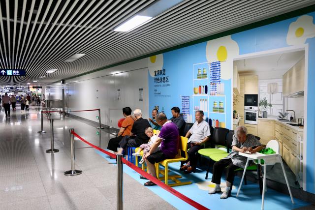 (260724) -- FUZHOU, July 24, 2026 (Xinhua) -- Residents enjoy leisure time at a rest area of a metro station to cool off in Fuzhou, southeast China's Fujian Province, July 24, 2026. As summer temperatures soar, Fuzhou has made some tunnels, air-raid shelters and metro stations available as public cooling spaces. Equipped with benches, chairs and other convenience facilities, these sites have become popular for residents to relax and escape the heat. (Xinhua/Jiang Kehong)