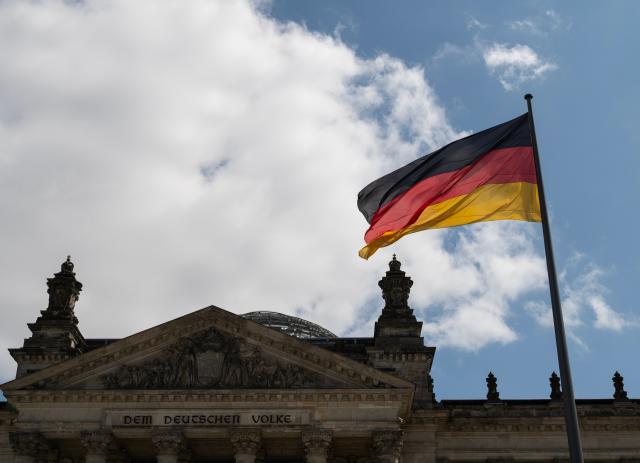 (260724) -- BERLIN, July 24, 2026 (Xinhua) -- This photo taken on July 24, 2026 shows a German national flag outside the Reichstag building in Berlin, Germany. German Chancellor Friedrich Merz on Friday announced a major reshuffle of his cabinet, highlighted by the appointment of Nina Warken as the new Chancellery head and Carsten Linnemann as the health minister. (Xinhua/Zhang Haofu)