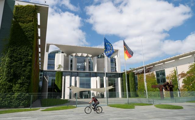 (260724) -- BERLIN, July 24, 2026 (Xinhua) -- A woman rides past the German Chancellery in Berlin, Germany, July 24, 2026. German Chancellor Friedrich Merz on Friday announced a major reshuffle of his cabinet, highlighted by the appointment of Nina Warken as the new Chancellery head and Carsten Linnemann as the health minister. (Xinhua/Zhang Haofu)