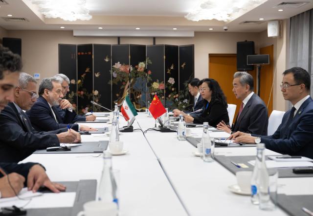 (260724) -- CHOLPON-ATA, July 24, 2026 (Xinhua) -- Chinese Foreign Minister Wang Yi, also a member of the Political Bureau of the Communist Party of China Central Committee, meets with Iranian Foreign Minister Seyed Abbas Araghchi on the sidelines of the Meeting of the Council of the Ministers of Foreign Affairs of the Shanghai Cooperation Organization (SCO) Member States in Kyrgyzstan, July 24, 2026. (Xinhua/Li Renzi)