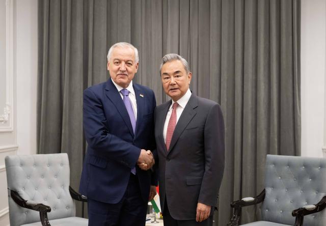 (260724) -- CHOLPON-ATA, July 24, 2026 (Xinhua) -- Chinese Foreign Minister Wang Yi, also a member of the Political Bureau of the Communist Party of China Central Committee, meets with Tajik Foreign Minister Sirojiddin Muhriddin on the sidelines of the Meeting of the Council of the Ministers of Foreign Affairs of the Shanghai Cooperation Organization (SCO) Member States in Kyrgyzstan, July 24, 2026. (Xinhua/Li Renzi)