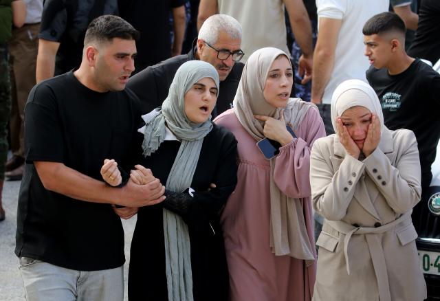(260724) -- NABLUS, July 24, 2026 (Xinhua) -- Relatives mourn during the funeral of four Palestinians who were killed in an incident, at a hospital in the West Bank city of Nablus, on July 24, 2026. Four Palestinians and one Israeli were killed on Friday in an incident in the town of Tal, south of the northern West Bank city of Nablus, authorities have said. According to local Palestinian sources, a group of Israeli settlers attacked homes in Tal and opened fire on residents, resulting in deaths and injuries. Meanwhile, the Israel Defense Forces (IDF) said in a statement that the incident began when Palestinians attacked Israeli hikers in the area. (Photo by Nidal Eshtayeh/Xinhua)