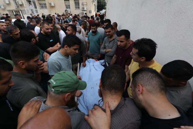 (260724) -- NABLUS, July 24, 2026 (Xinhua) -- Mourners attend the funeral of four Palestinians who were killed in an incident, at a hospital in the West Bank city of Nablus, on July 24, 2026. Four Palestinians and one Israeli were killed on Friday in an incident in the town of Tal, south of the northern West Bank city of Nablus, authorities have said. According to local Palestinian sources, a group of Israeli settlers attacked homes in Tal and opened fire on residents, resulting in deaths and injuries. Meanwhile, the Israel Defense Forces (IDF) said in a statement that the incident began when Palestinians attacked Israeli hikers in the area. (Photo by Nidal Eshtayeh/Xinhua)