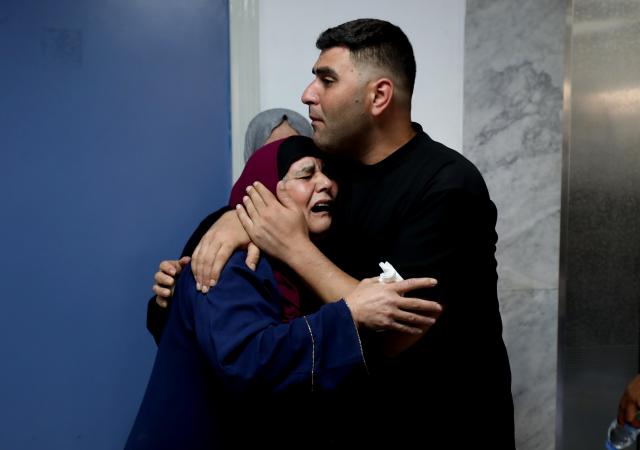 (260724) -- NABLUS, July 24, 2026 (Xinhua) -- Relatives mourn during the funeral of four Palestinians who were killed in an incident, at a hospital in the West Bank city of Nablus, on July 24, 2026. Four Palestinians and one Israeli were killed on Friday in an incident in the town of Tal, south of the northern West Bank city of Nablus, authorities have said. According to local Palestinian sources, a group of Israeli settlers attacked homes in Tal and opened fire on residents, resulting in deaths and injuries. Meanwhile, the Israel Defense Forces (IDF) said in a statement that the incident began when Palestinians attacked Israeli hikers in the area. (Photo by Nidal Eshtayeh/Xinhua)