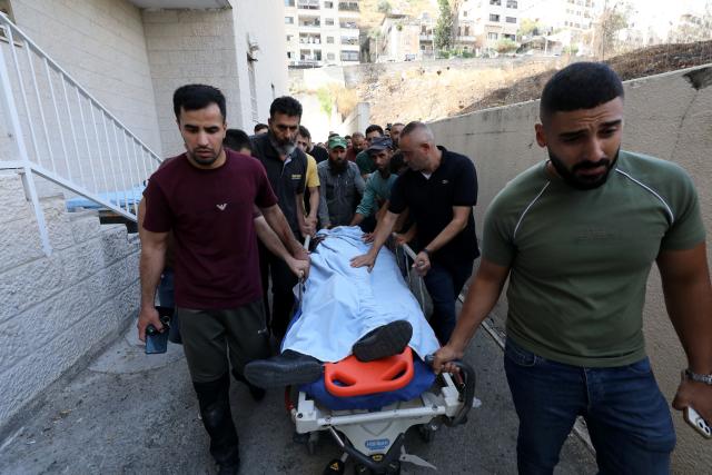 (260724) -- NABLUS, July 24, 2026 (Xinhua) -- Mourners attend the funeral of four Palestinians who were killed in an incident, at a hospital in the West Bank city of Nablus, on July 24, 2026. Four Palestinians and one Israeli were killed on Friday in an incident in the town of Tal, south of the northern West Bank city of Nablus, authorities have said. According to local Palestinian sources, a group of Israeli settlers attacked homes in Tal and opened fire on residents, resulting in deaths and injuries. Meanwhile, the Israel Defense Forces (IDF) said in a statement that the incident began when Palestinians attacked Israeli hikers in the area. (Photo by Nidal Eshtayeh/Xinhua)