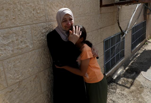(260724) -- NABLUS, July 24, 2026 (Xinhua) -- Relatives mourn during the funeral of four Palestinians who were killed in an incident, at a hospital in the West Bank city of Nablus, on July 24, 2026. Four Palestinians and one Israeli were killed on Friday in an incident in the town of Tal, south of the northern West Bank city of Nablus, authorities have said. According to local Palestinian sources, a group of Israeli settlers attacked homes in Tal and opened fire on residents, resulting in deaths and injuries. Meanwhile, the Israel Defense Forces (IDF) said in a statement that the incident began when Palestinians attacked Israeli hikers in the area. (Photo by Nidal Eshtayeh/Xinhua)