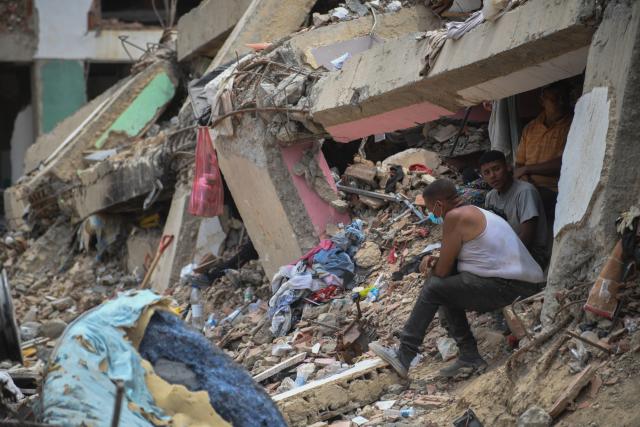 (260724) -- LA GUAIRA, July 24, 2026 (Xinhua) -- Rescuers work on a collapsed building in La Guaira State, Venezuela, July 23, 2026. The death toll from the June 24 earthquakes in Venezuela has risen to 5,398 as crews continue to clear rubble in the hardest-hit areas. (Photo by Marcos Salgado/Xinhua)