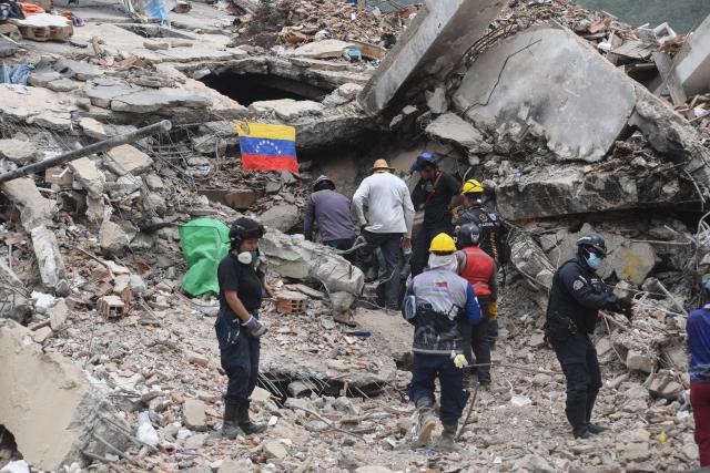 (260724) -- LA GUAIRA, July 24, 2026 (Xinhua) -- Rescuers work on a collapsed building in La Guaira State, Venezuela, July 23, 2026. The death toll from the June 24 earthquakes in Venezuela has risen to 5,398 as crews continue to clear rubble in the hardest-hit areas. (Photo by Marcos Salgado/Xinhua)