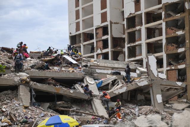 (260724) -- LA GUAIRA, July 24, 2026 (Xinhua) -- Rescuers work on a collapsed building in La Guaira State, Venezuela, July 23, 2026. The death toll from the June 24 earthquakes in Venezuela has risen to 5,398 as crews continue to clear rubble in the hardest-hit areas. (Photo by Marcos Salgado/Xinhua)