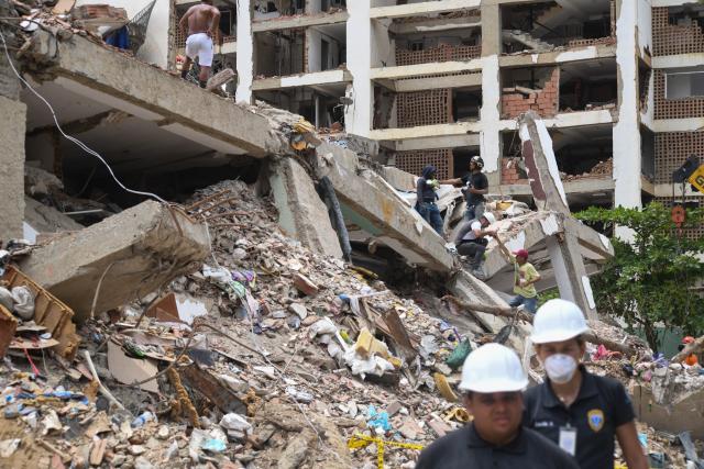 (260724) -- LA GUAIRA, July 24, 2026 (Xinhua) -- Rescuers work on a collapsed building in La Guaira State, Venezuela, July 23, 2026. The death toll from the June 24 earthquakes in Venezuela has risen to 5,398 as crews continue to clear rubble in the hardest-hit areas. (Photo by Marcos Salgado/Xinhua)