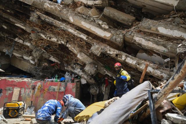 (260724) -- LA GUAIRA, July 24, 2026 (Xinhua) -- Rescuers work on a collapsed building in La Guaira State, Venezuela, July 23, 2026. The death toll from the June 24 earthquakes in Venezuela has risen to 5,398 as crews continue to clear rubble in the hardest-hit areas. (Photo by Marcos Salgado/Xinhua)