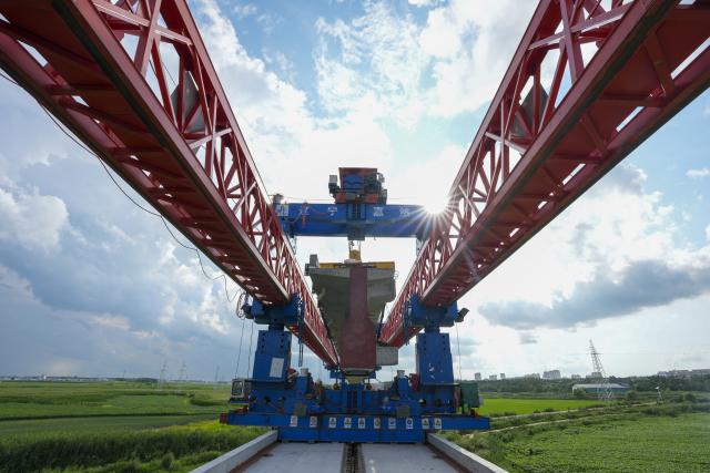 (260725) -- JIAMUSI, July 25, 2026 (Xinhua) -- This photo taken on July 23, 2026 shows the construction site of the Tongjiang super major bridge in northeast China's Heilongjiang Province. The beam erection work of the 10,435-meter Tongjiang super major bridge, which is part of the capacity expansion and upgrading project for the Jiamusi-Tongjiang Railway, was successfully completed on Saturday. 
   Upon completion, the 258-kilometer-long railway will boost the transport capacity of Tongjiang port, a key gateway along the eastern route of the China-Europe freight train service. (Xinhua/Wang Song)
