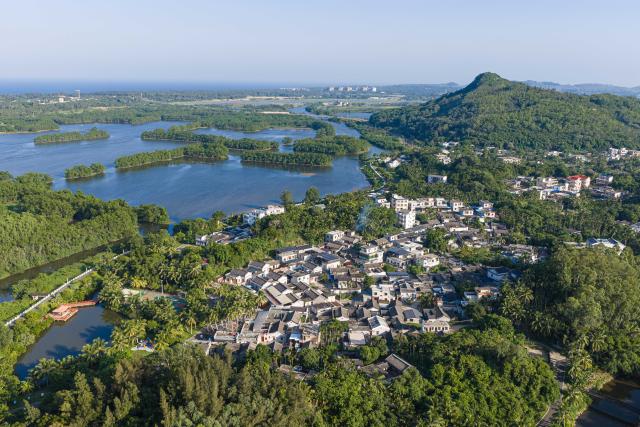 (260725) -- QIONGHAI, July 25, 2026 (Xinhua) -- An aerial drone photo taken on July 22, 2026 shows the scenery of Shamei Village in Boao Town, Qionghai City, south China's Hainan Province. Building on the unique identities of Boao Town, home to the Boao Forum for Asia, and Tanmen Town, a historic fishing port with a thousand-year legacy, Qionghai City has been advancing the coordinated construction of picturesque rural villages across the Boao-Tanmen area. Taking advantage of Hainan's round-the-island highway, the city has linked both newly constructed and previously cultivated beautiful and harmonious villages into a cohesive chain to forge a globally influential rural revitalization belt. (Xinhua/Pu Xiaoxu)
