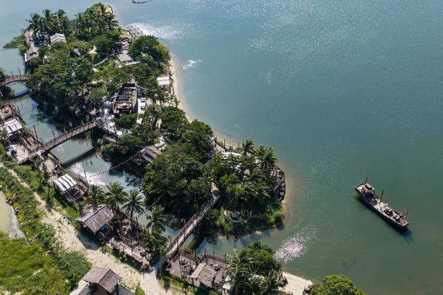 (260725) -- QIONGHAI, July 25, 2026 (Xinhua) -- An aerial drone photo taken on July 22, 2026 shows the scenery of Liuke Village in Boao Town, Qionghai City, south China's Hainan Province. Building on the unique identities of Boao Town, home to the Boao Forum for Asia, and Tanmen Town, a historic fishing port with a thousand-year legacy, Qionghai City has been advancing the coordinated construction of picturesque rural villages across the Boao-Tanmen area. Taking advantage of Hainan's round-the-island highway, the city has linked both newly constructed and previously cultivated beautiful and harmonious villages into a cohesive chain to forge a globally influential rural revitalization belt. (Xinhua/Pu Xiaoxu)