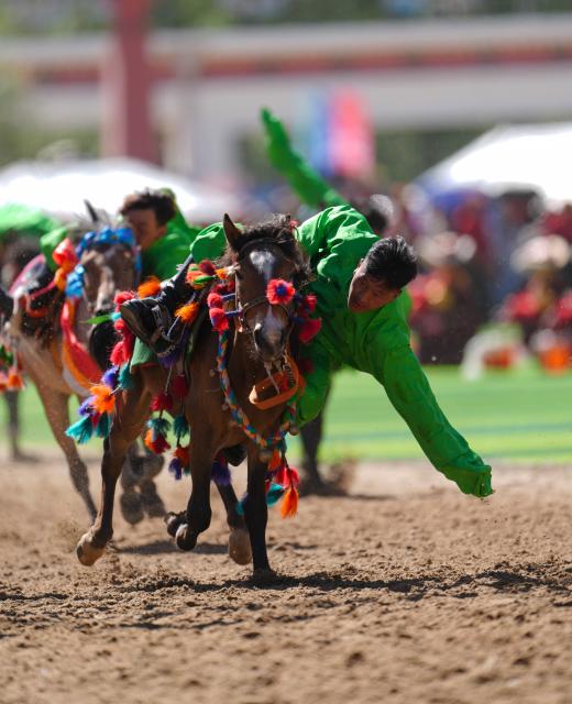 (260725) -- YUSHU, July 25, 2026 (Xinhua) -- Riders show off equestrian stunts during the opening ceremony of the 44th Yushu horse racing festival in Yushu Tibetan Autonomous Prefecture, northwest China's Qinghai Province, July 25, 2026. The festival kicked off here on Saturday, and will last until August. (Xinhua/Du Xiaowei)