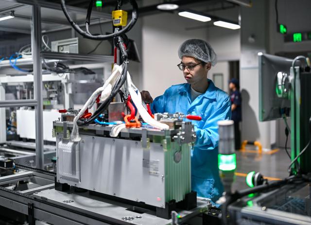 (260725) -- NANTONG, July 25, 2026 (Xinhua) -- A staff member works in an energy storage production workshop at the Sigenergy Nantong Smart Energy Center in Nantong, east China's Jiangsu Province, July 24, 2026. Unlike traditional factories, Sigenergy has achieved a leap from "single-point automation" to "full-process collaborative intelligence." Every key piece of equipment here is connected to the industrial internet, realizing the practical integration of "AI plus energy."
   Sigenergy is one of the Chinese new energy enterprises who are adhering to technological innovation and actively reshaping the new pattern of intelligent manufacturing. (Xinhua/Chen Yehua)