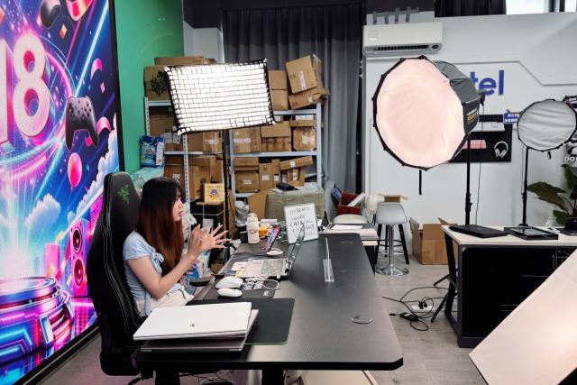 (260725) -- HANGZHOU, July 25, 2026 (Xinhua) -- A livestreamer works at Zhejiang Global Netrepreneur Co., Ltd. in Hangzhou City, east China's Zhejiang Province, May 21, 2026. TO GO WITH "China Focus: Beyond livestream: Can clicks become lasting careers for China's youth?" (Xinhua/Zheng Keyi)