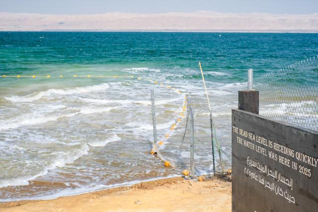 (260726) -- AMMAN, July 26, 2026 (Xinhua) -- This photo taken on July 25, 2026 shows a sign marking the former water level near the Dead Sea in Jordan. The Dead Sea has been experiencing a long-term decline in its water level due to reduced inflow from the Jordan River, the region's naturally high evaporation rates, and industrial mineral extraction. Available data show that as of July 2026, the Dead Sea's surface was approximately 440 meters below sea level, and its water level has been declining by an average of more than one meter annually. (Xinhua/Xin Mengchen)