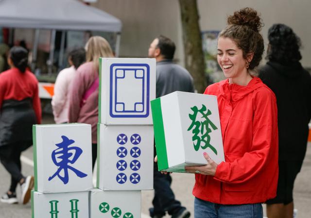 (260726) -- VANCOUVER, July 26, 2026 (Xinhua) -- A visitor participates in a mahjong-themed activity during the Chinatown Festival in Vancouver, British Columbia, Canada, July 25, 2026. The two-day cultural festival kicked off here on Saturday, celebrating the heritage of Vancouver's historic Chinatown with traditional cultural performances, local food vendors and family-friendly activities. (Photo by Liang Sen/Xinhua)
