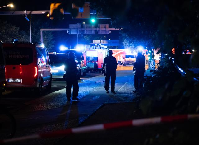 (260726) -- BERLIN, July 26, 2026 (Xinhua) -- Police officers work near the site where a car drove into a crowd in Berlin, Germany, July 26, 2026. One person was killed and 16 others were injured, including several with life-threatening injuries, after a car drove into a crowd at a large Pride celebration in central Berlin on Saturday evening, a police spokesperson said. (Xinhua/Zhang Haofu)