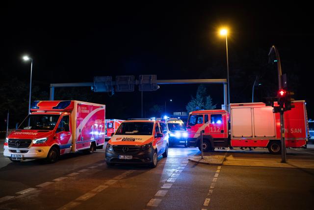 (260726) -- BERLIN, July 26, 2026 (Xinhua) -- Rescue vehicles are pictured near the site where a car drove into a crowd in Berlin, Germany, July 26, 2026. One person was killed and 16 others were injured, including several with life-threatening injuries, after a car drove into a crowd at a large Pride celebration in central Berlin on Saturday evening, a police spokesperson said. (Xinhua/Zhang Haofu)