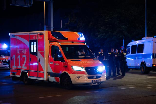 (260726) -- BERLIN, July 26, 2026 (Xinhua) -- An ambulance arrives at the site where a car drove into a crowd in Berlin, Germany, July 26, 2026. One person was killed and 16 others were injured, including several with life-threatening injuries, after a car drove into a crowd at a large Pride celebration in central Berlin on Saturday evening, a police spokesperson said. (Xinhua/Zhang Haofu)