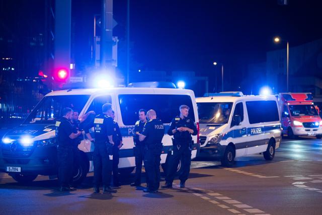 (260726) -- BERLIN, July 26, 2026 (Xinhua) -- Police officers work near the site where a car drove into a crowd in Berlin, Germany, July 26, 2026. One person was killed and 16 others were injured, including several with life-threatening injuries, after a car drove into a crowd at a large Pride celebration in central Berlin on Saturday evening, a police spokesperson said. (Xinhua/Zhang Haofu)