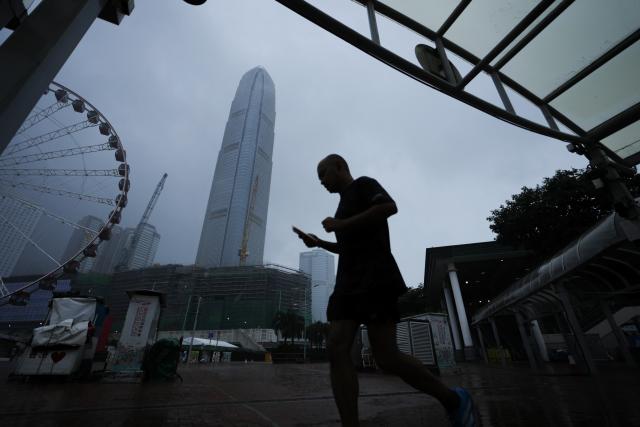 (260726) -- HONG KONG, July 26, 2026 (Xinhua) -- A man walks on a street in Hong Kong, south China, July 26, 2026. The Hong Kong Observatory issued the No. 8 Northwest Gale or Storm Signal on Saturday night under the effect of super typhoon Noul.
   The No. 8 signal is the third-highest warning under Hong Kong's weather system, which has five rankings for typhoons. (Photo by Lui Siu Wai/Xinhua)