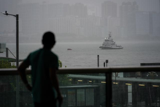 (260726) -- HONG KONG, July 26, 2026 (Xinhua) -- A passerby looks towards the Victoria Harbour in Hong Kong, south China, July 26, 2026. The Hong Kong Observatory downgraded the typhoon signal to the Strong Wind Signal No. 3 at 12:40 p.m. local time on Sunday as Typhoon Noul moves away.
   With Noul moving into inland Guangdong and weakening, local winds are decreasing gradually, according to the observatory. (Xinhua/Zhu Wei)