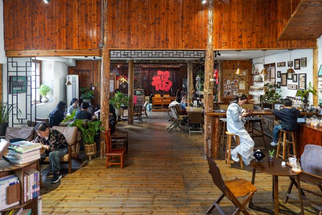 (260726) -- WENLING, July 26, 2026 (Xinhua) -- Tourists enjoy their leisure time at a cafe renovated from a traditional stone house in Liruo Village of Shitang Town, Wenling City, east China's Zhejiang Province, May 2, 2026. Liruo is a village located in the southwestern part of Shitang Town, Wenling City. For generations, local residents have relied on the sea for their livelihood. The village is known for its distinctive stone constructions, which were built to withstand typhoons and other severe weather.
   Today, the ancient fishing village is boosting its cultural and tourism industries. Many traditional stone houses have been transformed into cafes and homestays, while fishing nets are crafted into handbags, serving as souvenirs for tourists together with other cultural and creative products. (Xinhua/Jiang Han)