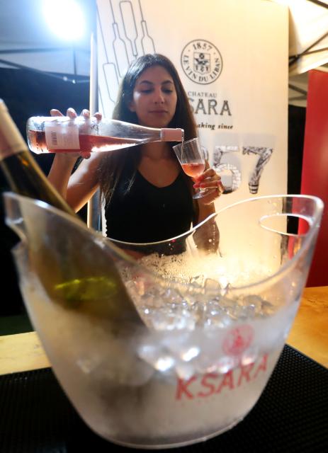 (260726) -- DHOUR CHOUEIR, July 26, 2026 (Xinhua) -- A woman attends a wine festival held in Dhour Choueir, Lebanon, on July 25, 2026. (Xinhua/Bilal Jawich)
