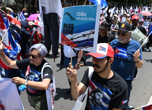(260726) -- MEXICO CITY, July 26, 2026 (Xinhua) -- Protesters march during a demonstration in support of Cuba and against U.S. embargo on Cuba, in Mexico City, Mexico on July 26, 2026. The demonstration aimed to commemorate the 73rd anniversary of the assault on Moncada and Carlos Manuel de Cespedes garrisons that took place on July 26, 1953, seen as the beginning of the Cuban Revolution. (Xinhua/Wu Wei)